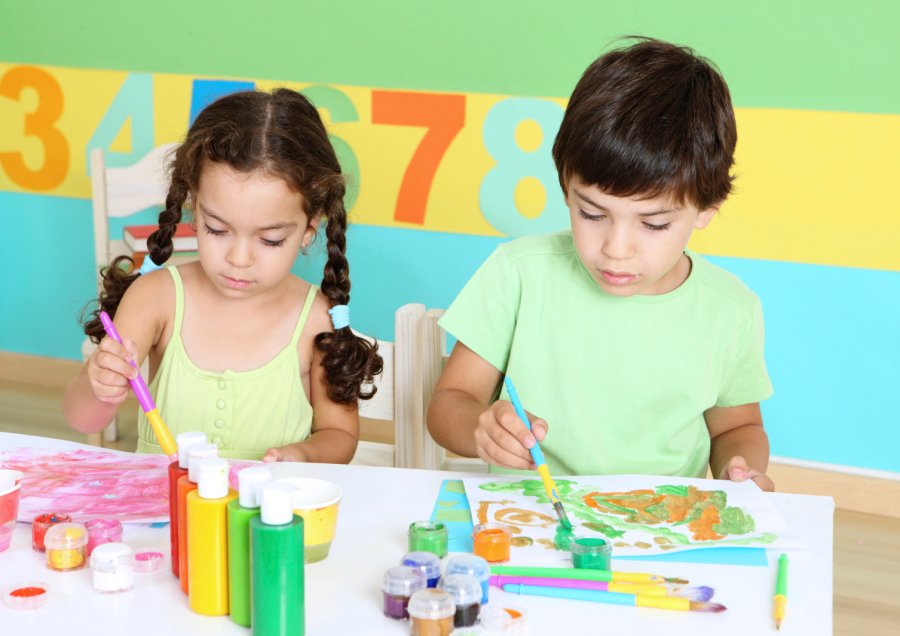 Children painting and playing safely